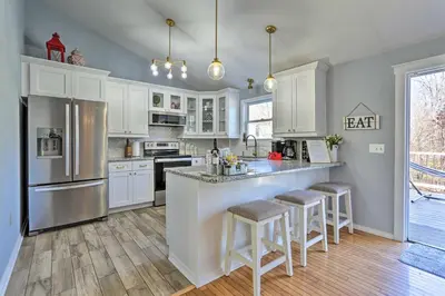 a kitchen with white cabinets and stainless steel appliances at Hot Tub, Fire Pit and Resort Perks Tobyhanna Home! in Tobyhanna