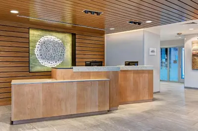a lobby with a reception desk in a building at Fairfield Inn & Suites by Marriott Selinsgrove in Selinsgrove