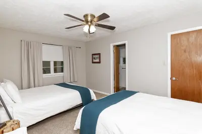 a bedroom with two beds and a ceiling fan at Camelback Rd Rancher- On ONE ACRE & near attractions in Tannersville