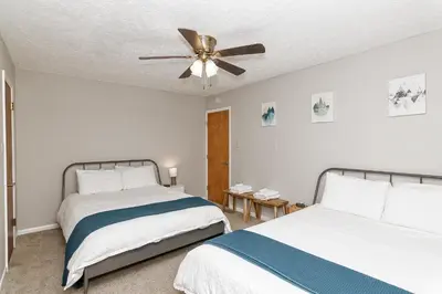 a bedroom with two beds and a ceiling fan at Camelback Rd Rancher- On ONE ACRE & near attractions in Tannersville
