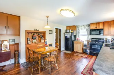 a kitchen with a wooden table and a dining room at 11 Mi to Jack Frost Resort Winter Family Getaway! in White Haven