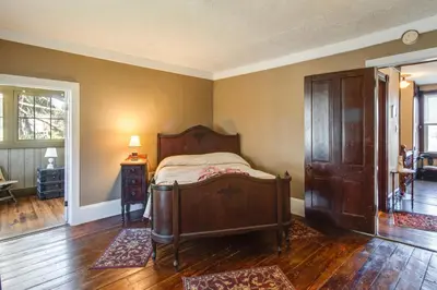 a bedroom with a bed in a room with wooden floors at 11 Mi to Jack Frost Resort Winter Family Getaway! in White Haven