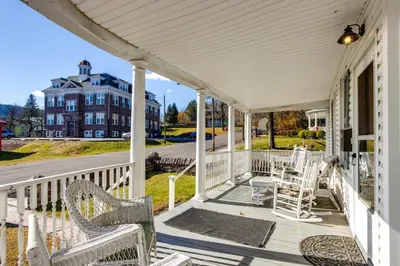 a white porch with chairs and a building at 11 Mi to Jack Frost Resort Winter Family Getaway! in White Haven
