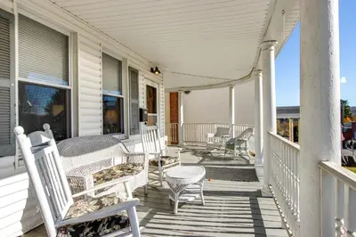 a porch with chairs and tables on a house at 11 Mi to Jack Frost Resort Winter Family Getaway! in White Haven