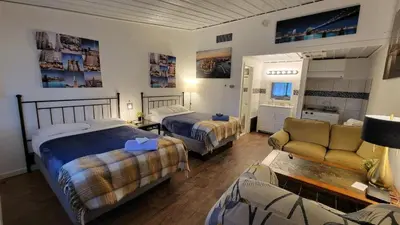 a hotel room with two beds and a couch at Sussex Motel in Wantage