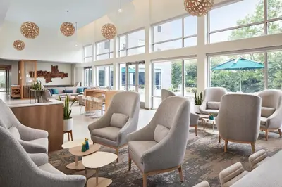 a waiting room with chairs and tables and windows at Element Valley Forge King of Prussia in King of Prussia