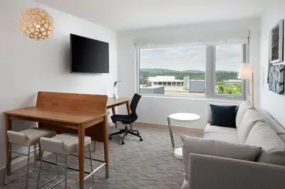 a living room with a couch and a table and a desk at Element Valley Forge King of Prussia in King of Prussia