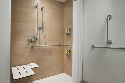 a shower stall in a bathroom with wooden tiles at Element Valley Forge King of Prussia in King of Prussia