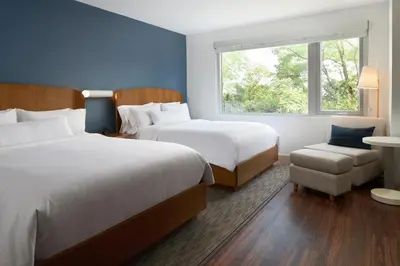a hotel room with two beds and a chair at Element Valley Forge King of Prussia in King of Prussia