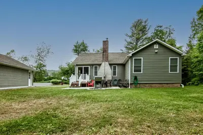 a house with a lawn in front of it at Cabin by the Creek with private creek access in Tannersville