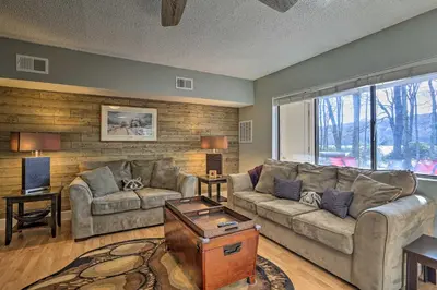 a living room with a couch and a table at On Big Boulder Lake Condo with Community Pools! in Lake Harmony