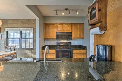a kitchen with a sink and a stove top oven at On Big Boulder Lake Condo with Community Pools! in Lake Harmony