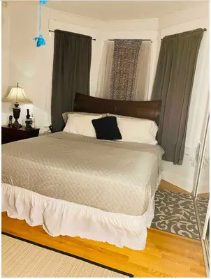 a bedroom with a bed with a black pillow on it at Nice 2 bedrooms, Massage Seat, close to New York, THE BEST CHOICE!! in North Bergen