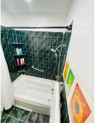 a green tiled bathroom with a tub and a shower at Nice 2 bedrooms, Massage Seat, close to New York, THE BEST CHOICE!! in North Bergen