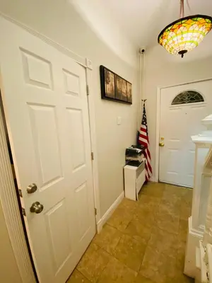 a hallway with a white door and an american flag at Nice 2 bedrooms, Massage Seat, close to New York, THE BEST CHOICE!! in North Bergen