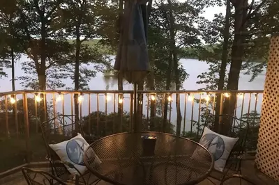 a table and chairs on a balcony with lights at LAKEFRONT Penthouse at Jack Frost Big Boulder in Lake Harmony