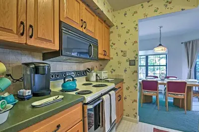 a kitchen with wooden cabinets and a stove top oven at LAKEFRONT Penthouse at Jack Frost Big Boulder in Lake Harmony