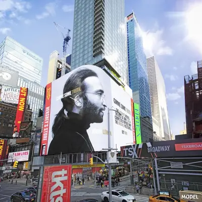 a billboard of a man with glasses on a city street at Riu Plaza Manhattan Times Square in New York