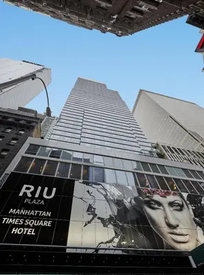 a tall building with a movie poster on the side of it at Riu Plaza Manhattan Times Square in New York