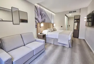 a hotel room with a bed and a couch at Riu Plaza Manhattan Times Square in New York