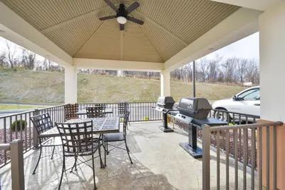 a screened porch with a table and chairs and a television at Candlewood Suites Harrisburg-Hershey by IHG in Harrisburg