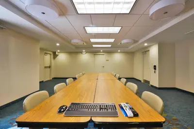 a large conference room with a keyboard on a table at Candlewood Suites Harrisburg-Hershey by IHG in Harrisburg