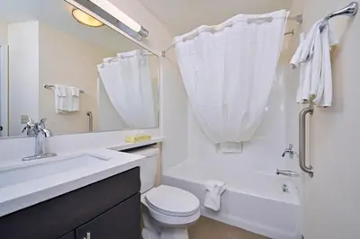 a bathroom with a sink and a toilet and a shower at Candlewood Suites Harrisburg-Hershey by IHG in Harrisburg