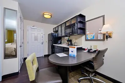 a kitchen and dining room with a table and chairs at Candlewood Suites Harrisburg-Hershey by IHG in Harrisburg
