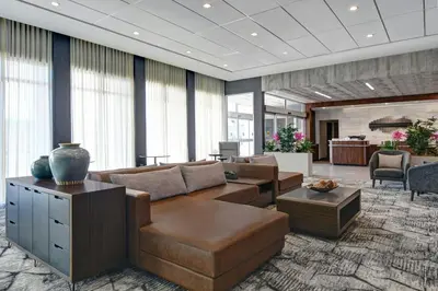 a large living room with couches and a table at Courtyard by Marriott Hamilton in Hamilton