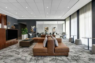 a large living room with a couch and a table at Courtyard by Marriott Hamilton in Hamilton