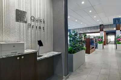 a lobby of an office building with a lobby plant at Courtyard by Marriott Hamilton in Hamilton