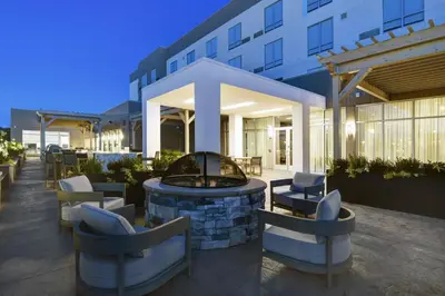 a patio with a fire pit in front of a building at Courtyard by Marriott Hamilton in Hamilton