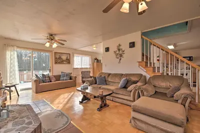 a living room with couches and a table at Private Hot Tub and Fireplace Poconos Home! in Pleasant Mount