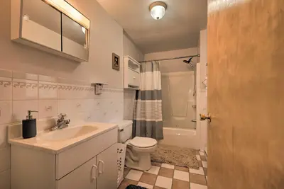 a white bathroom with a sink and a toilet at Private Hot Tub and Fireplace Poconos Home! in Pleasant Mount
