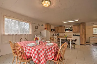 a kitchen and dining room with a table and chairs at Private Hot Tub and Fireplace Poconos Home! in Pleasant Mount