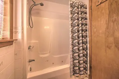 a shower in a bathroom with a shower curtain at Private Hot Tub and Fireplace Poconos Home! in Pleasant Mount
