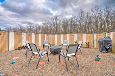 a group of chairs sitting around a fire pit at Private Hot Tub and Fireplace Poconos Home! in Pleasant Mount