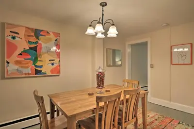 a dining room with a wooden table and chairs at Cozy Lambertville Abode in the Heart of Downtown! in Lambertville