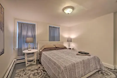 a bedroom with a bed and two lamps and a window at Cozy Lambertville Abode in the Heart of Downtown! in Lambertville