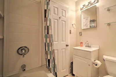 a bathroom with a shower and a toilet and a sink at Cozy Lambertville Abode in the Heart of Downtown! in Lambertville