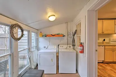 a kitchen with a white refrigerator and a washer and dryer at Cozy Lambertville Abode in the Heart of Downtown! in Lambertville