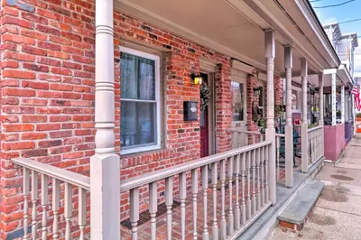 a brick building with a balcony on a street at Cozy Lambertville Abode in the Heart of Downtown! in Lambertville