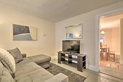 a living room with a couch and a television at Cozy Lambertville Abode in the Heart of Downtown! in Lambertville