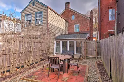 a patio with a table and chairs in front of a fence at Cozy Lambertville Abode in the Heart of Downtown! in Lambertville