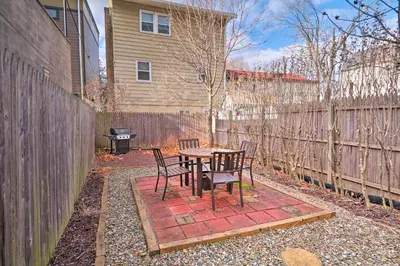 a patio with a table and chairs next to a fence at Cozy Lambertville Abode in the Heart of Downtown! in Lambertville