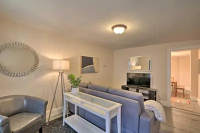a living room with a blue couch and a tv at Cozy Lambertville Abode in the Heart of Downtown! in Lambertville