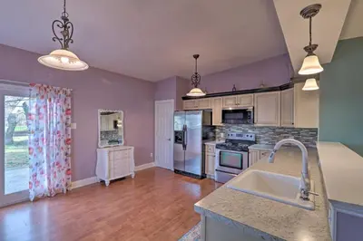a kitchen with purple walls and a counter top at Colorful Abode with Yard, 9 Mi to Sesame Place! in Bristol
