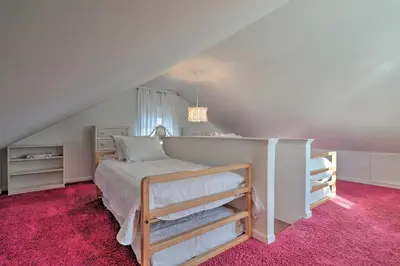 a bedroom with a bed and a pink carpet at Colorful Abode with Yard, 9 Mi to Sesame Place! in Bristol