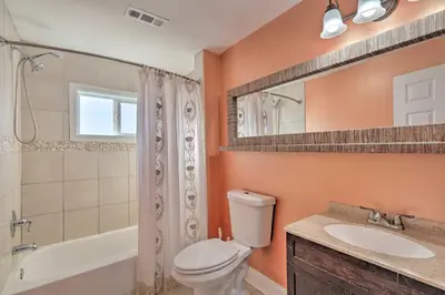 a bathroom with a toilet and a sink and a shower at Colorful Abode with Yard, 9 Mi to Sesame Place! in Bristol