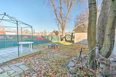 a park with a bench and a tree at Colorful Abode with Yard, 9 Mi to Sesame Place! in Bristol